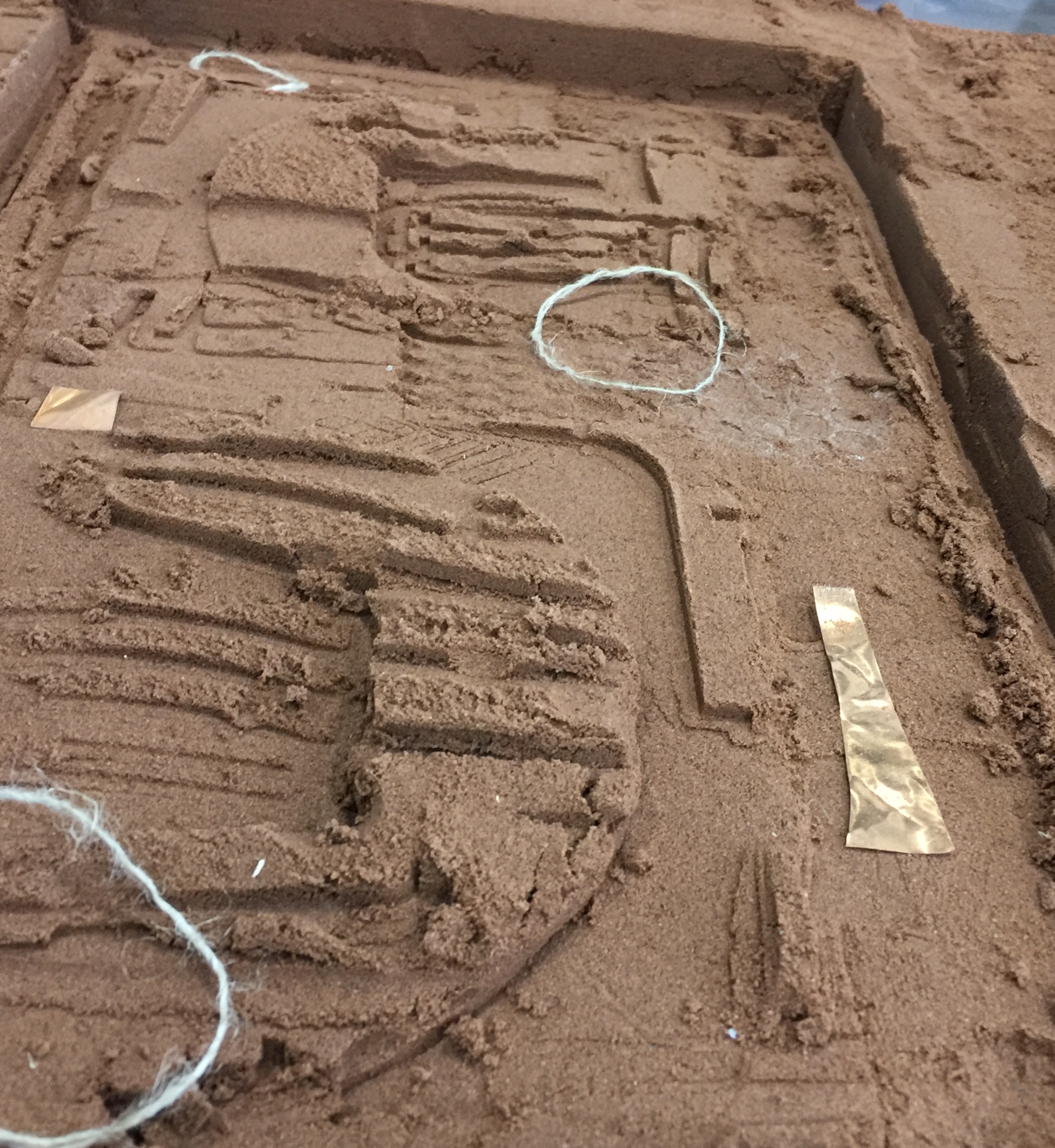 Showing the drawing in the sand 